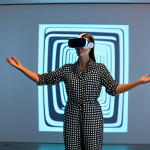A professional artist, fully clothed in a modest, contemporary jumpsuit, interacting with an immersive augmented reality art installation in a minimalist gallery. Vibrant digital light patterns and abstract forms seamlessly merge with the physical space around her, visible through a sleek AR headset. She stands in a natural pose, reaching out as if to touch a holographic projection. Well-formed hands, correct proportions, perfect anatomy, appropriate attire, safe for work, professional photography, high quality, family-friendly.